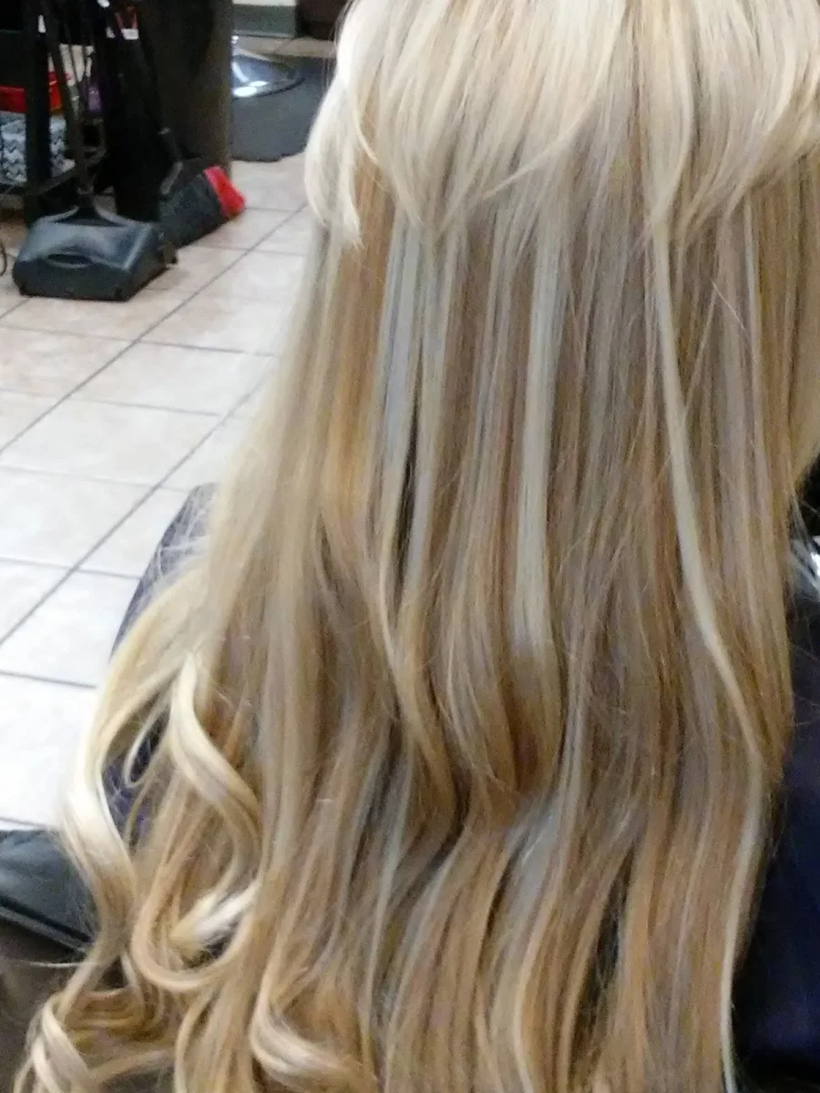 Blonde highlights and soft waves styled at Yes We Do